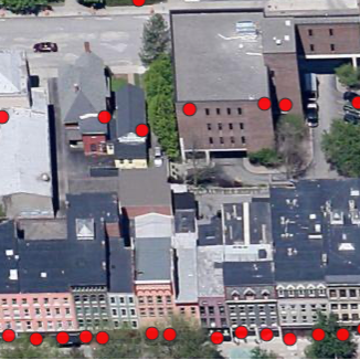 A bird's-eye-view image of buildings in Tompkins County with red dots on them. The red dots represent the people who lived at that location throughout history.