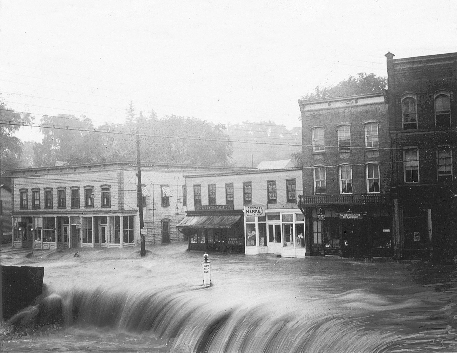 Image of a flooded street and storefronts